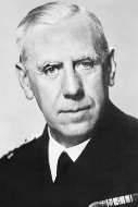 Elderly man in a military uniform with short white hair and a serious expression, facing forward against a plain background.